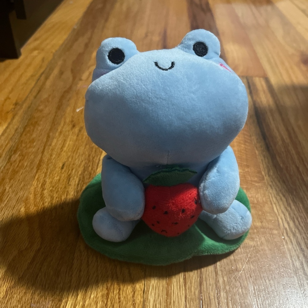 small plush frog with strawberry on lilypad